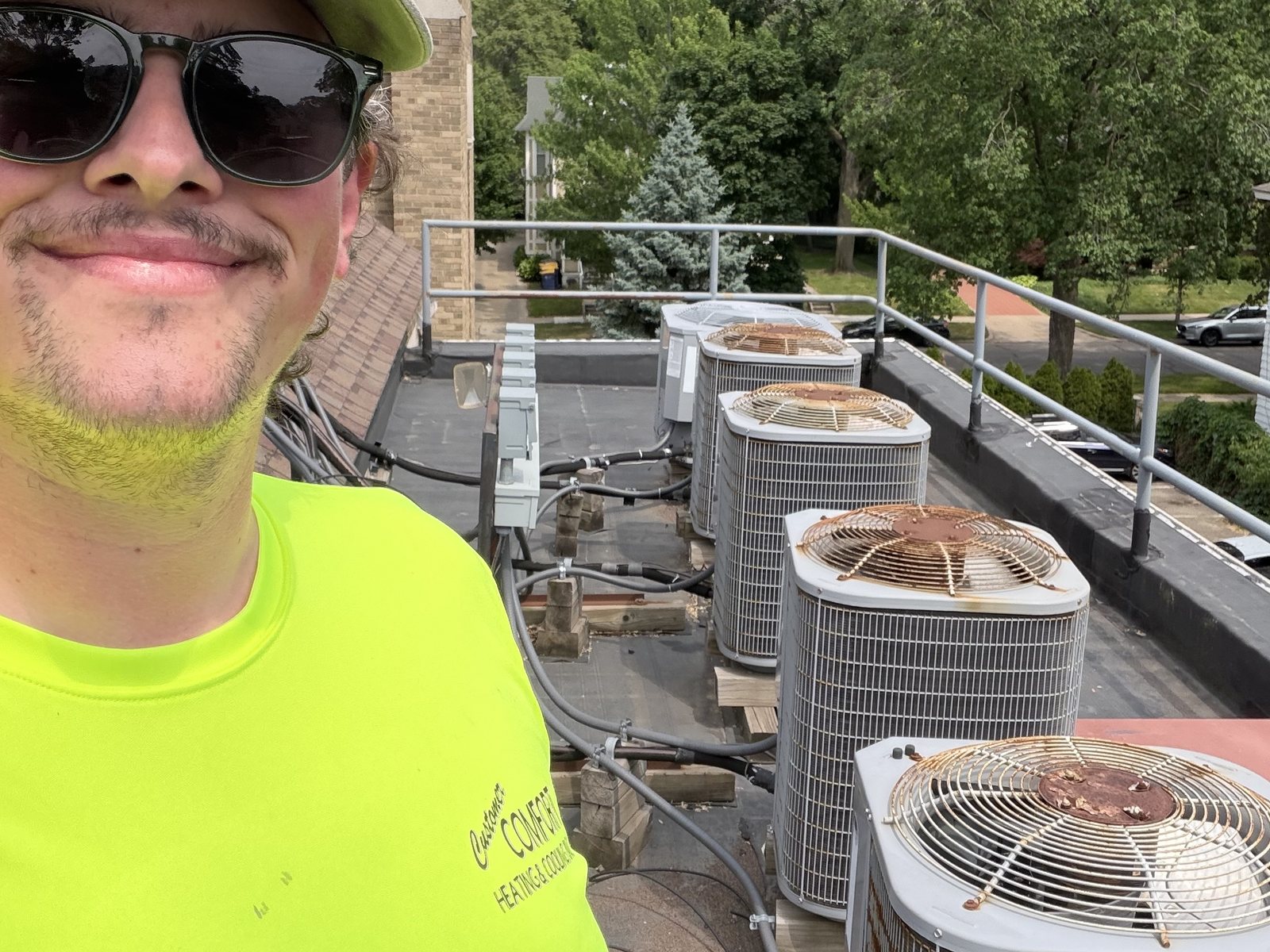 KC on a rooftop with a row of condensers