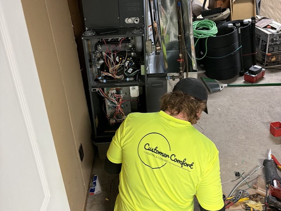 Furnace repair in progress, parts on a drop cloth