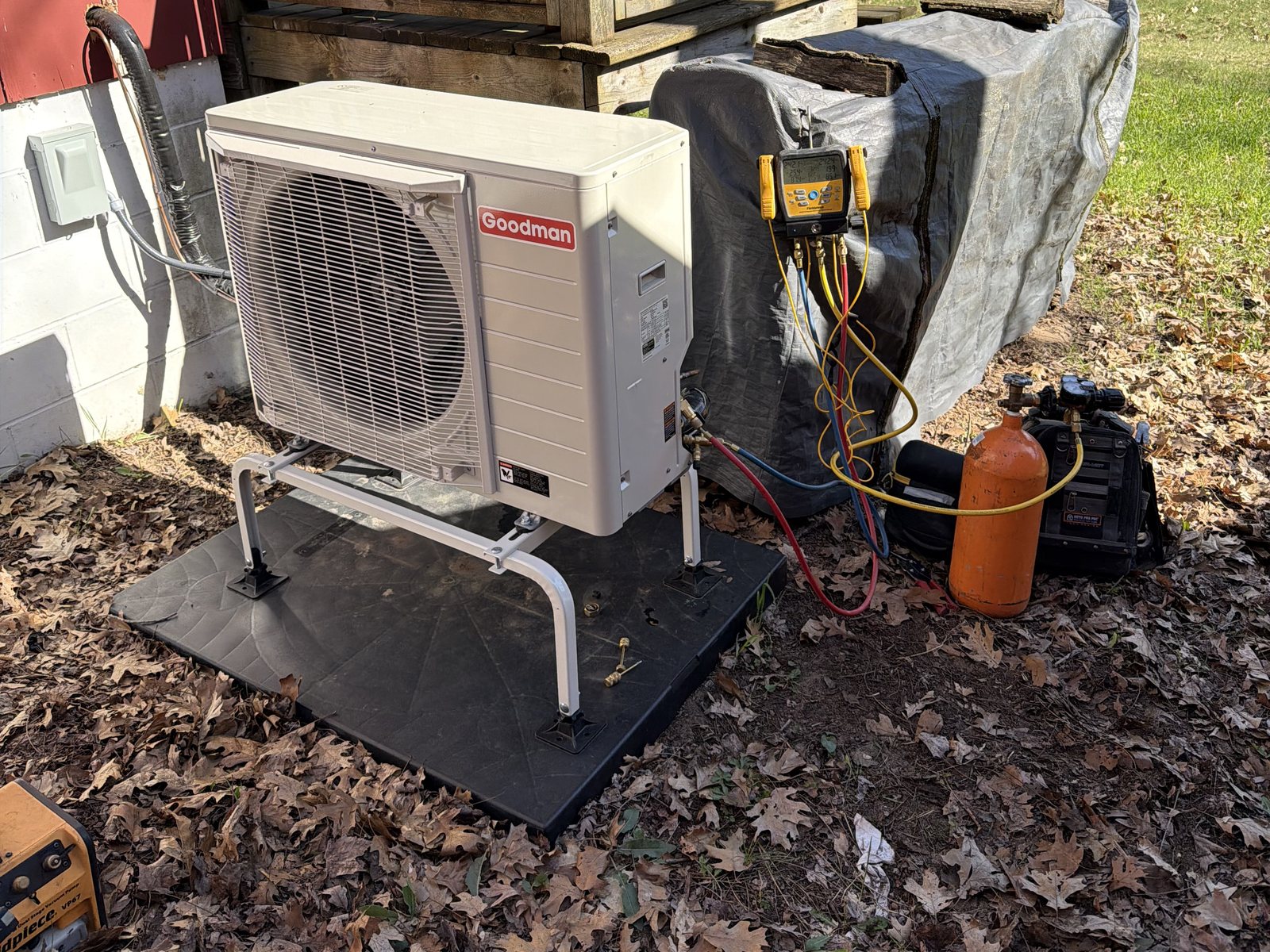 Goodman side-discharge heat pump on a stand, gauges hooked up