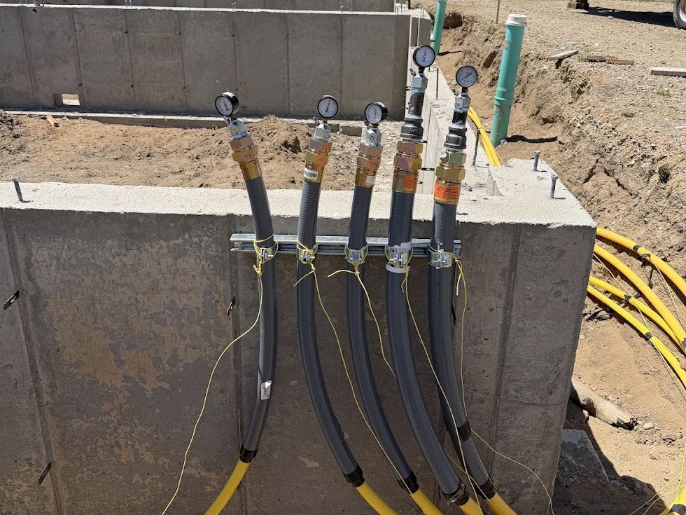 Gas lines pressure tested at a row of new foundations