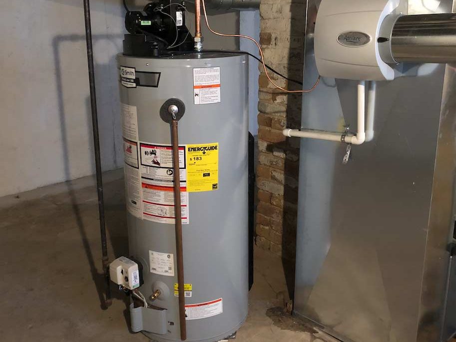 New water heater installed with clean copper and a drip pan